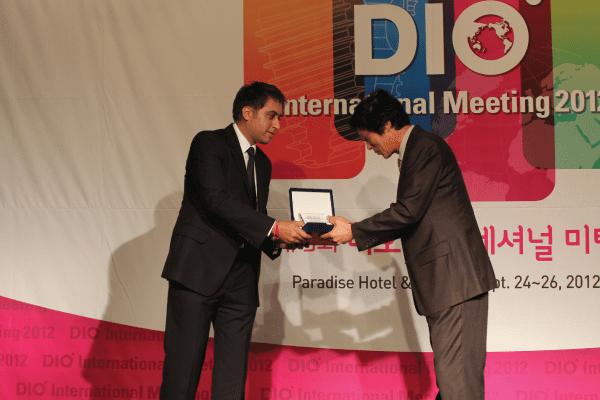 Dr Anoup Nandra receiving the DIO International Speaker dental award Rock Dental Wolverhampton Dentist