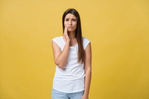 young woman has a dental emergency toothache