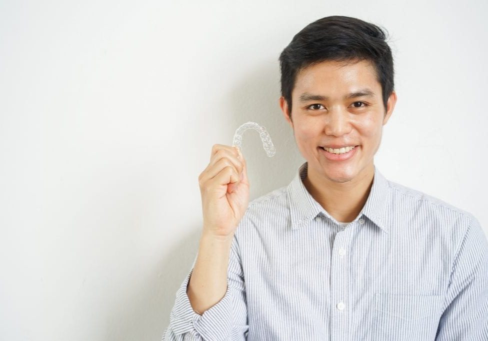 Invisalign Aligner held up by man at Dentist In Wolverhampton